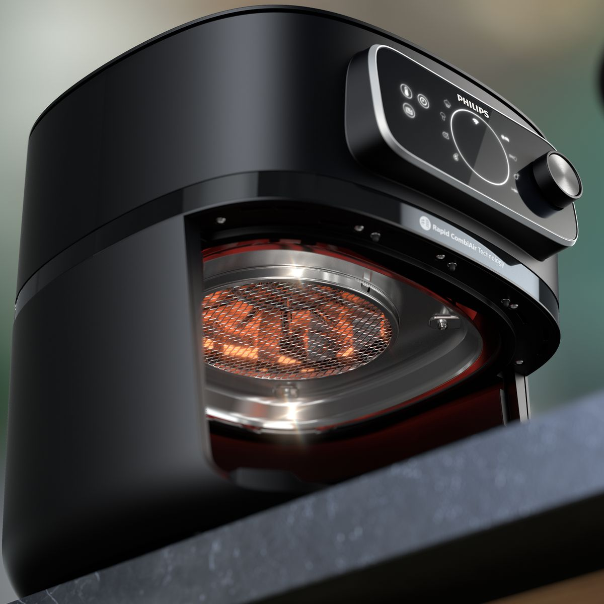 Zbliżenie czarnej frytkownicy powietrznej Philips, otwartej, aby pokazać element grzejny. Znajduje się na ciemnym blacie.