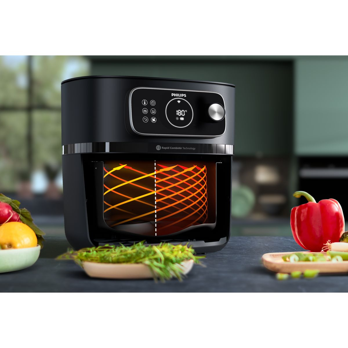 Czarna frytkownica Philips z wyświetlaczem 180°. Czerwona papryka, miska z zielenią i cytryna na ciemnym blacie.