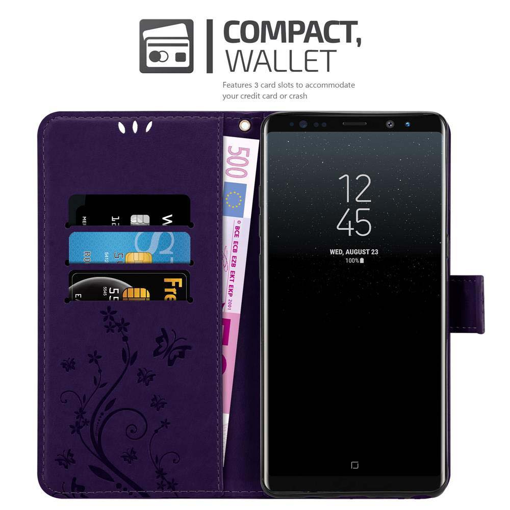 Portafoglio viola con telefono. Carte e banconota da 500 euro visibili. Il telefono mostra ora, data e batteria.