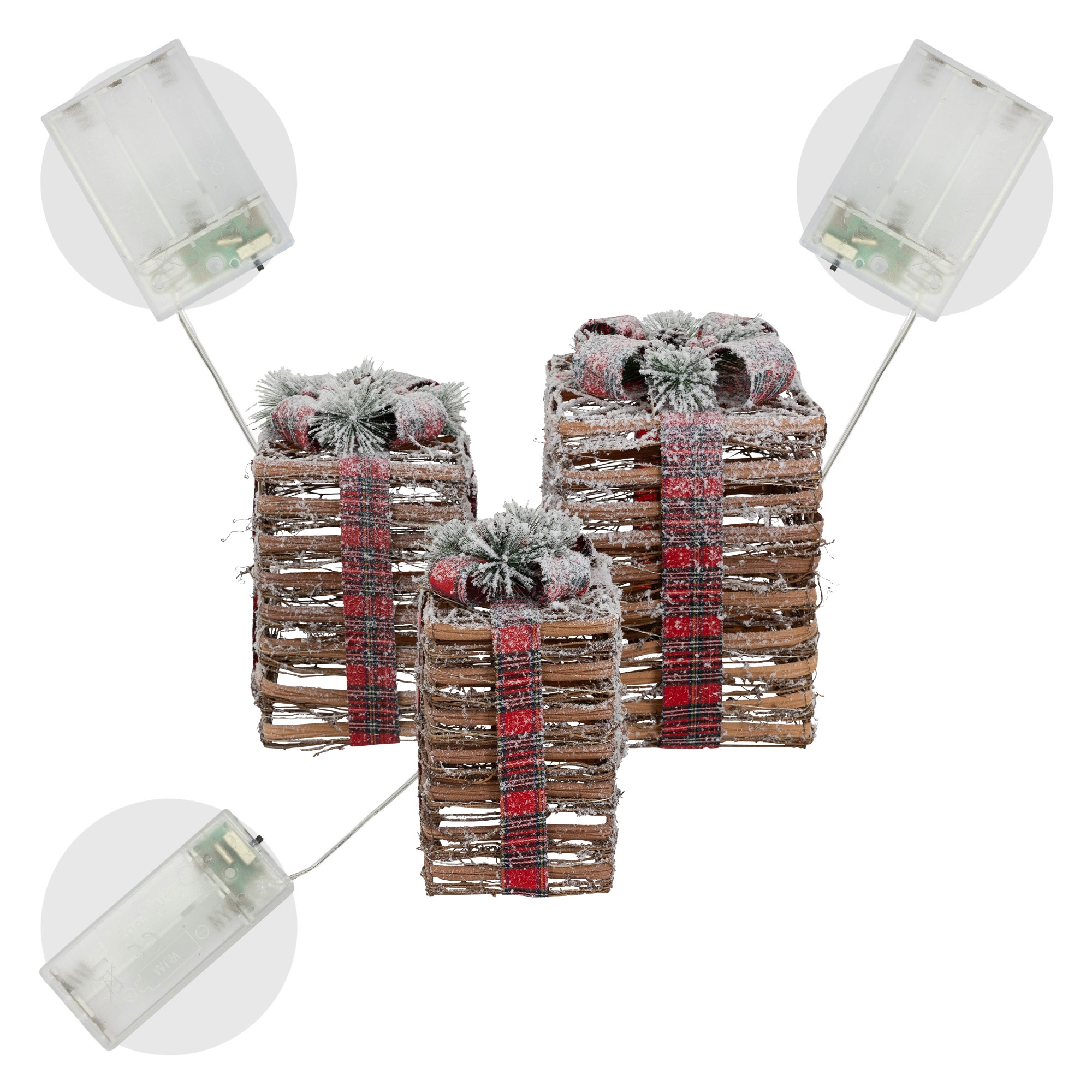 Drei Geschenkboxen aus Weide mit roten Karobändern und Schneeakzenten, beleuchtet von batteriebetriebenen Lichtern.
