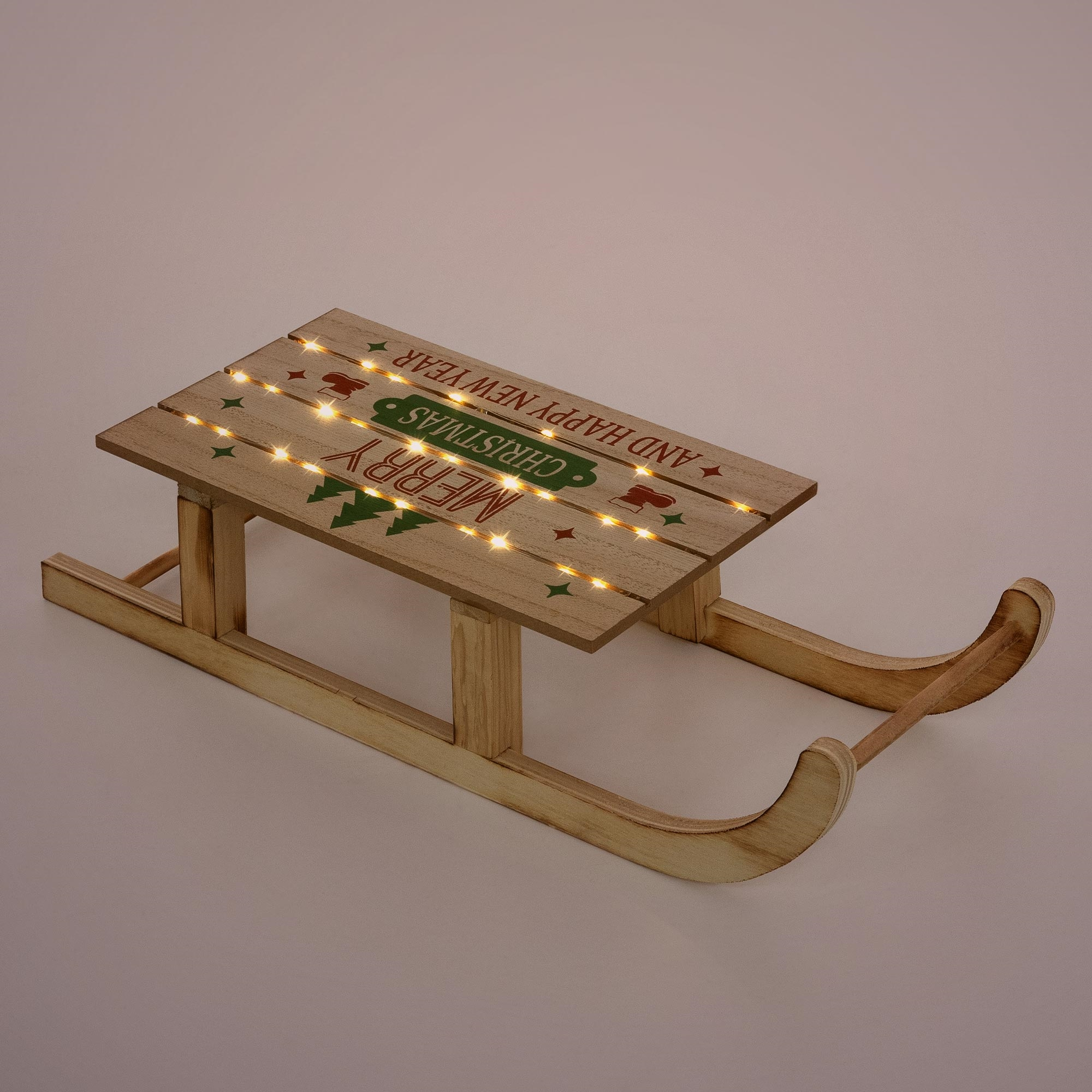 Holzschlitten mit LED-Leuchten. Auf der Oberseite stehen Weihnachtsgrüße.