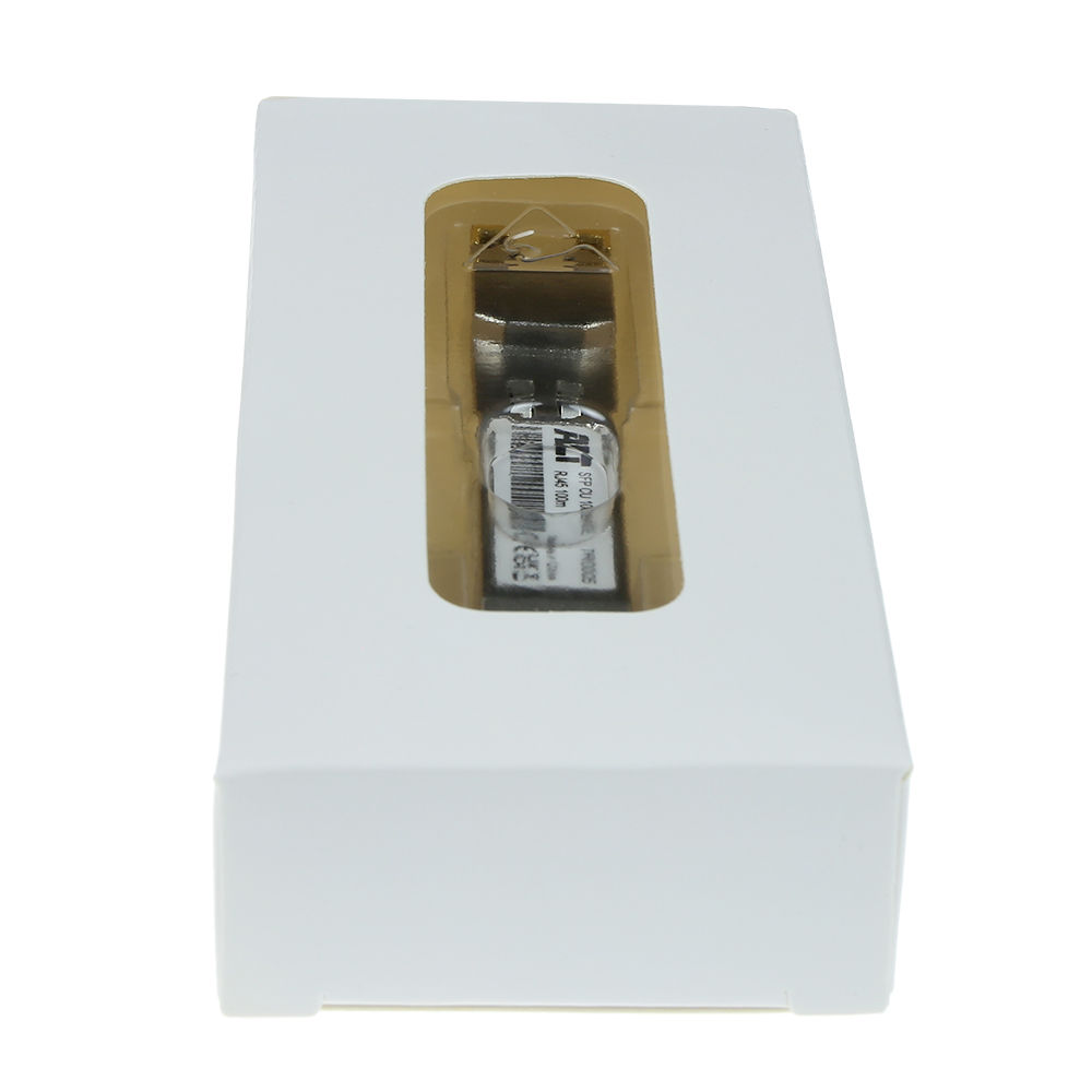 Białe pudełko z przezroczystym okienkiem. W środku widoczne jest srebrno-czarne urządzenie, oznaczone tekstem i kodem kreskowym.