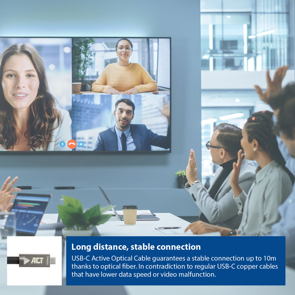 People in a meeting with a screen showing other people. A cable and text about long distance connection are at the bottom.