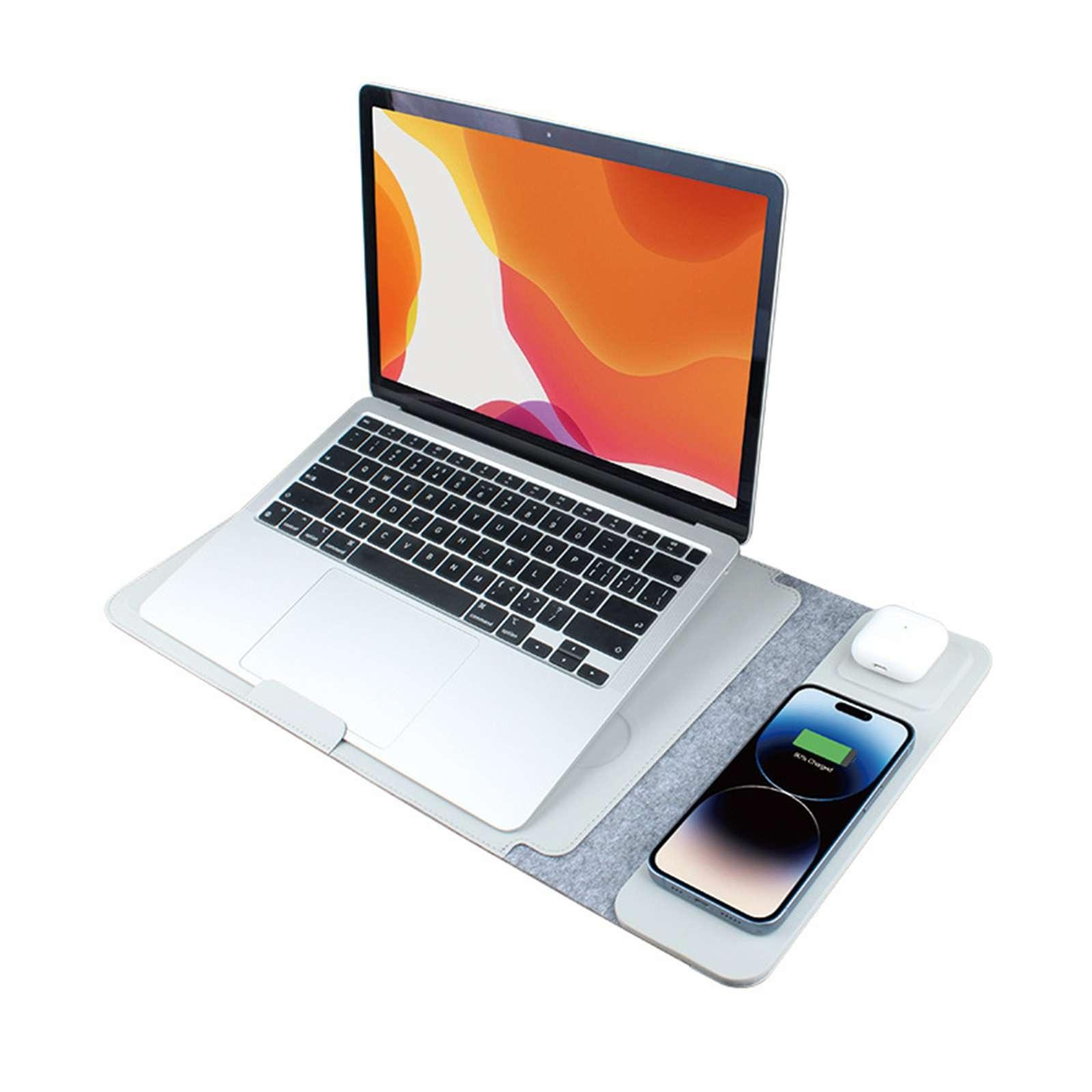 Ein Laptop liegt auf einem Pad mit einem ladenden Telefon und Ohrhörern. Der Laptop-Bildschirm zeigt farbenfrohe Grafiken.