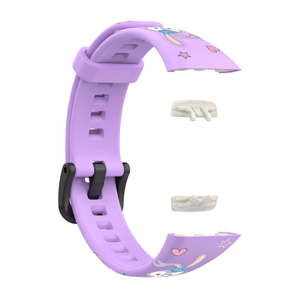Ein zerlegtes lila Uhrenarmband mit Cartoon-Hasen-Design und schwarzer Schließe. Zwei kleine weiße Stecker sind ebenfalls sichtbar.