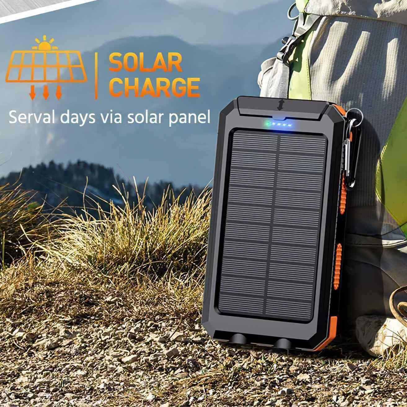Solar Ladegerät auf felsigem Untergrund. Das Ladegerät ist schwarz und orange, mit einem Solarpanel. Ein Rucksack ist im Hintergrund.