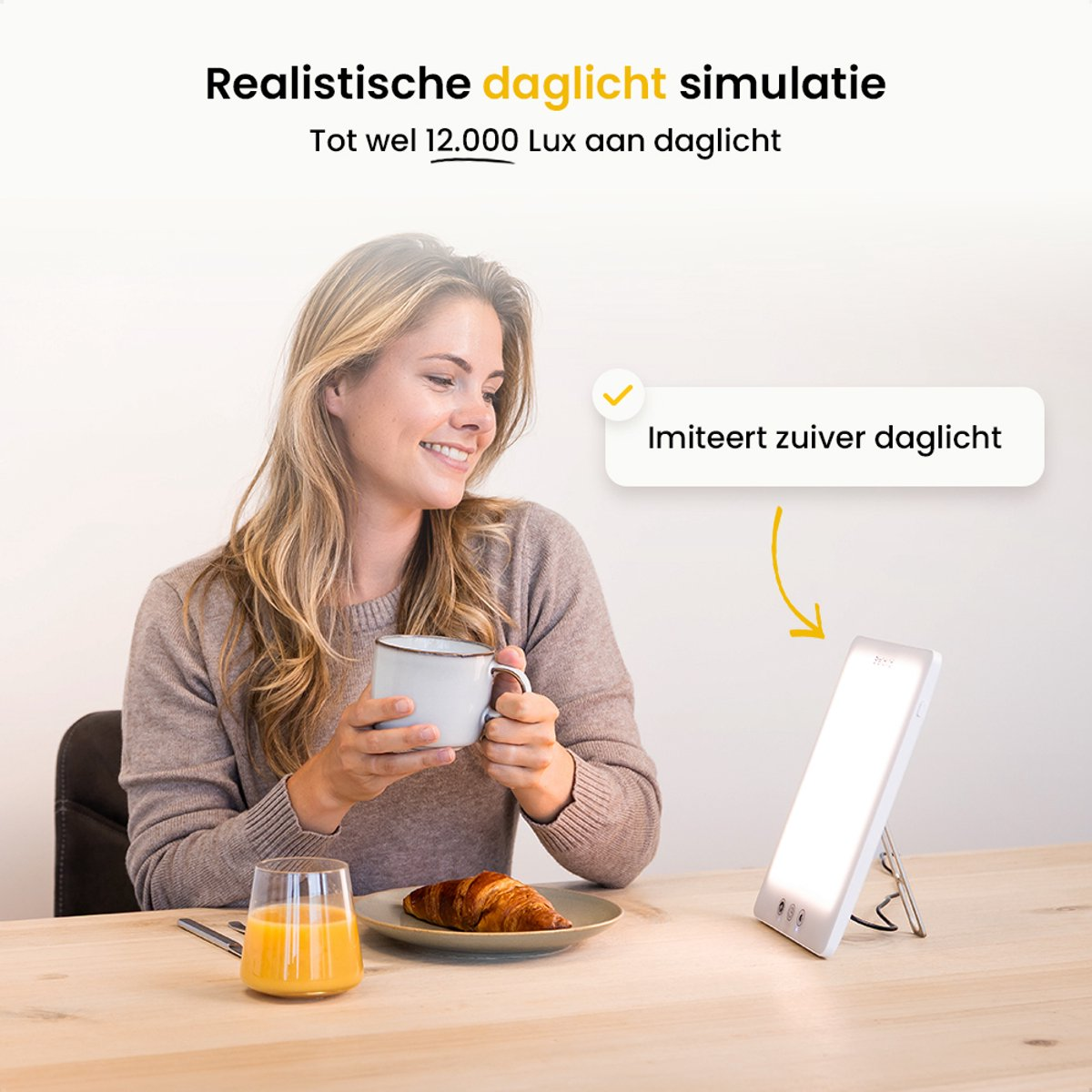 Woman smiles, holding a mug, near a breakfast with juice and croissant, a light panel on the table.