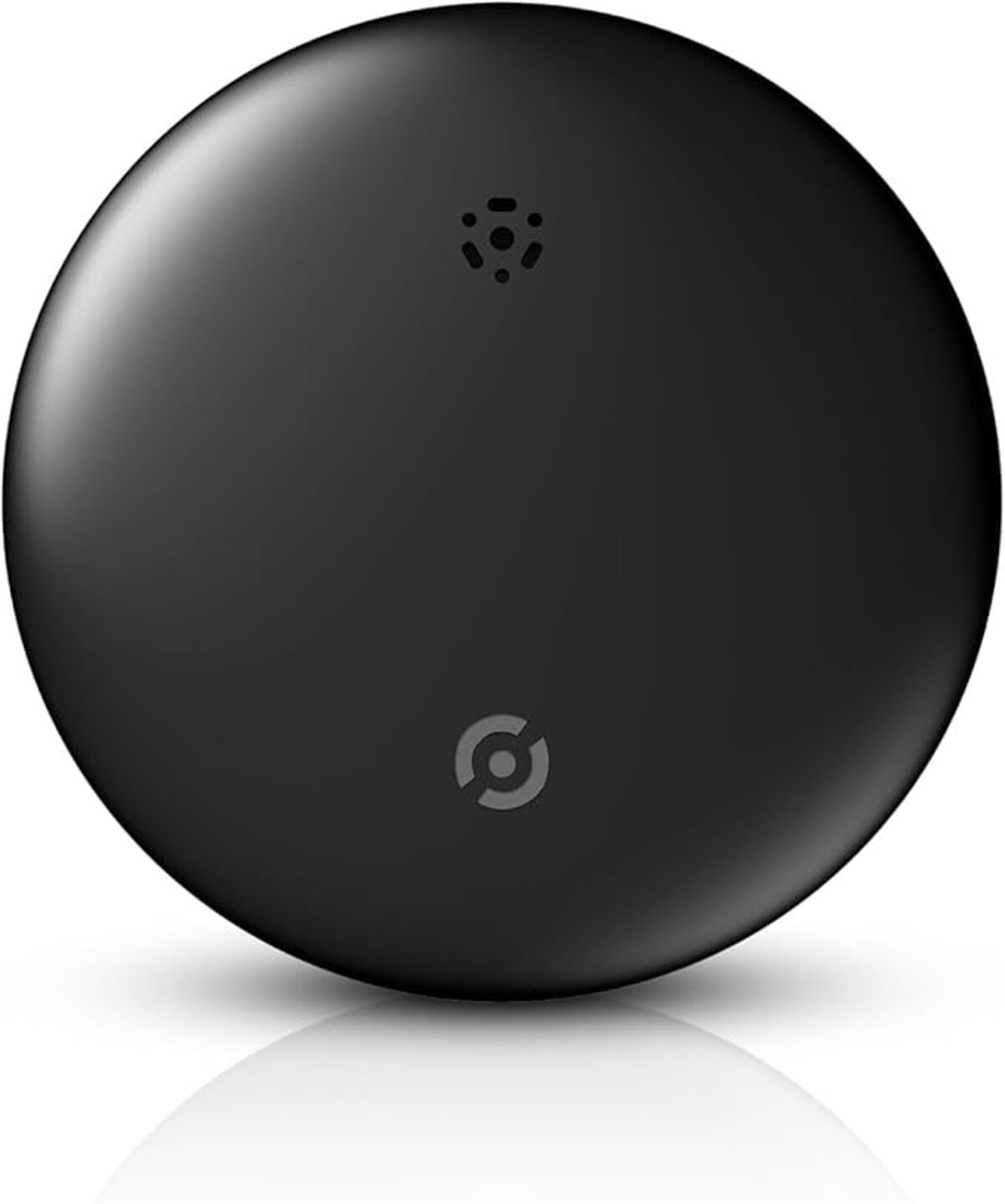 Un dispositivo negro y circular con acabado brillante. Tiene un pequeño logotipo y unos agujeros en la parte superior. Una reflexión abajo.