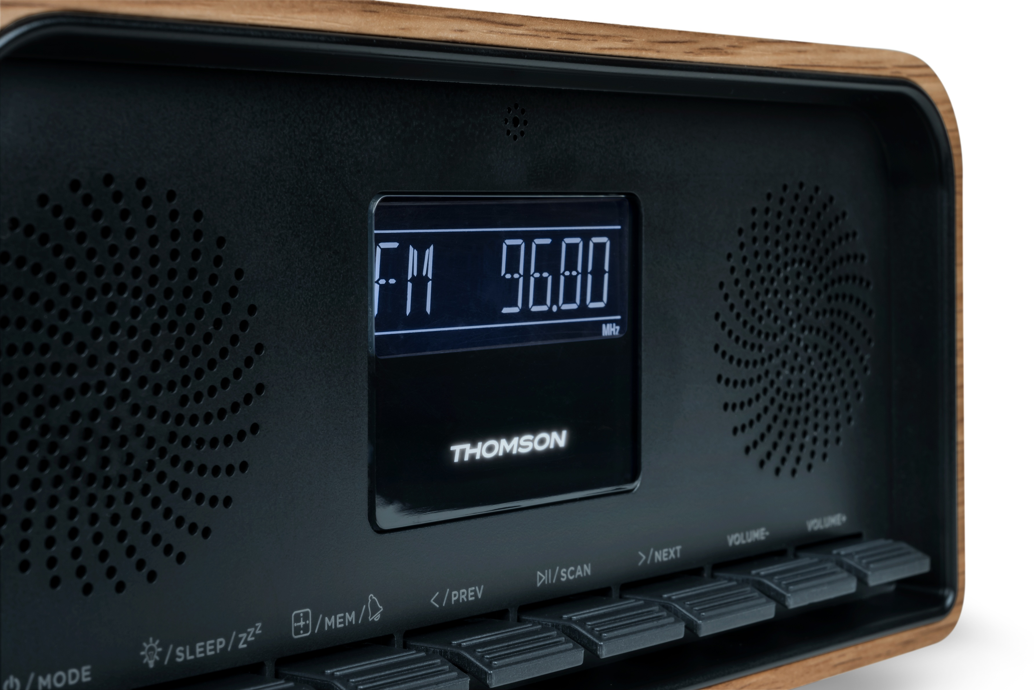 A close-up of a Thomson radio. The display shows FM 96.80. There are buttons and speakers on the radio.