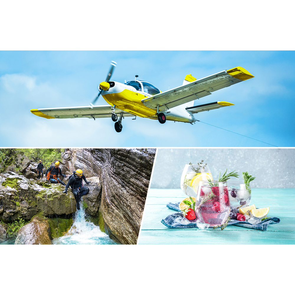 Ein gelb-weißes Flugzeug am Himmel. Unten Leute in Neoprenanzügen an einem Wasserfall. Getränke mit Früchten rechts.
