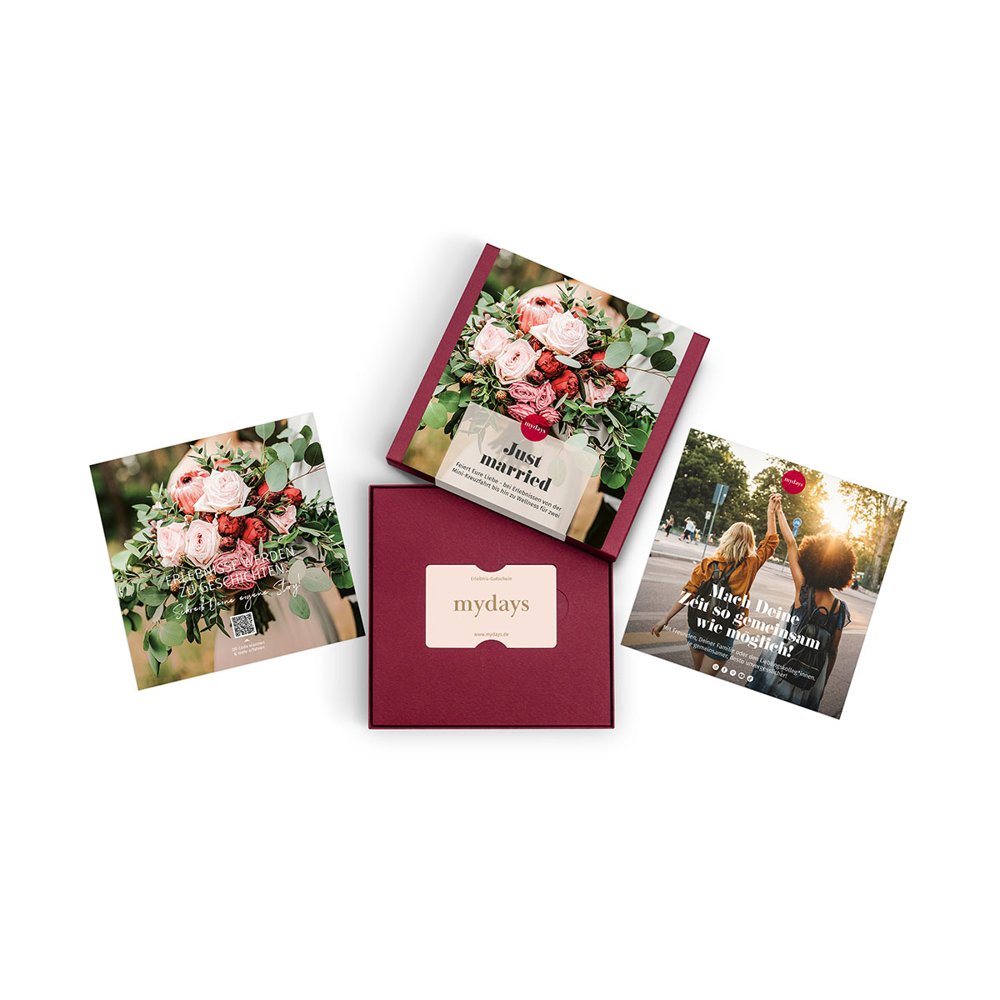 Vier Werbeartikel werden angezeigt, darunter eine Geschenkbox und Karten mit Blumen und einem Paar, die 'mydays' bewerben.