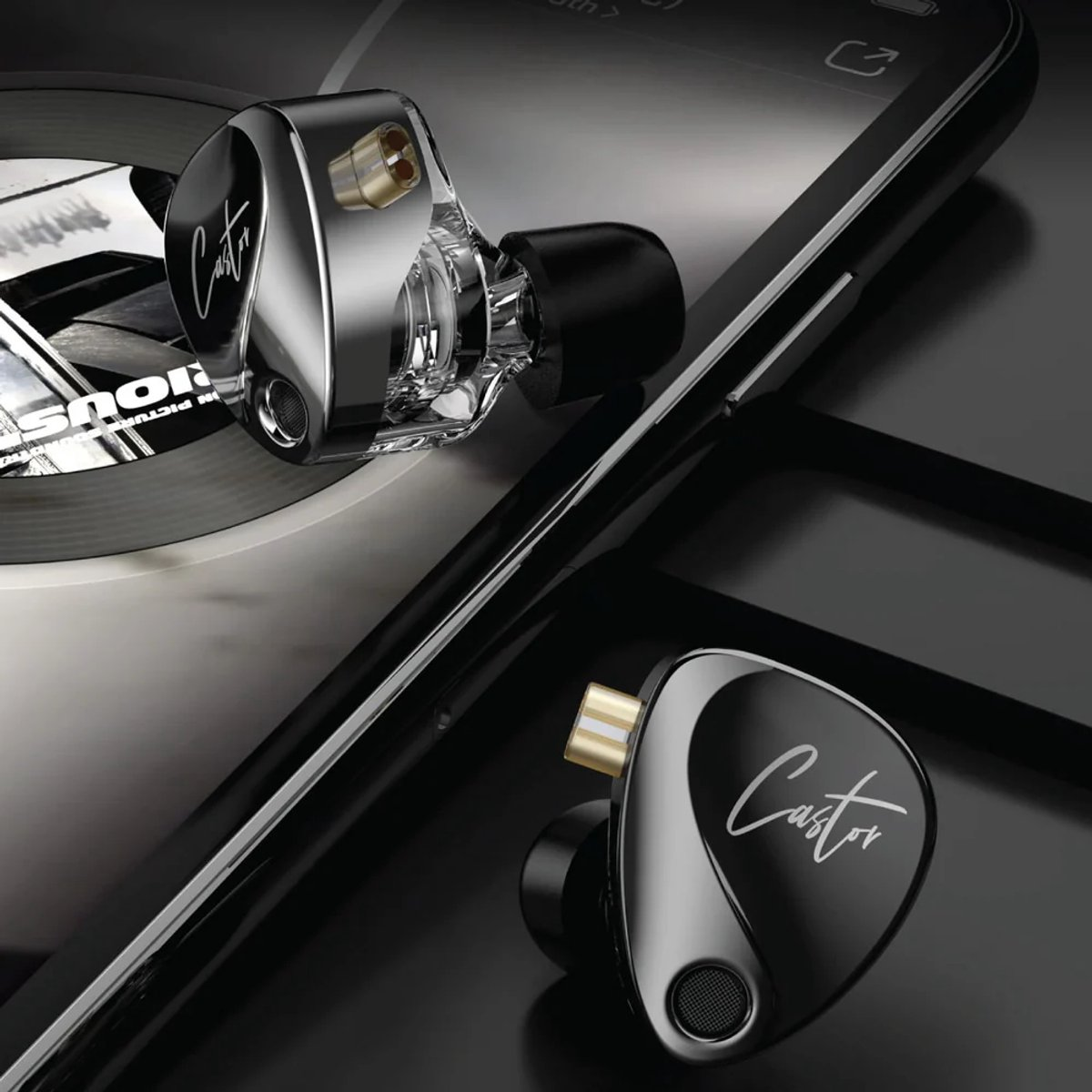 Two in-ear headphones on a black smartphone. One is clear, the other black with white script. Background is a black surface.