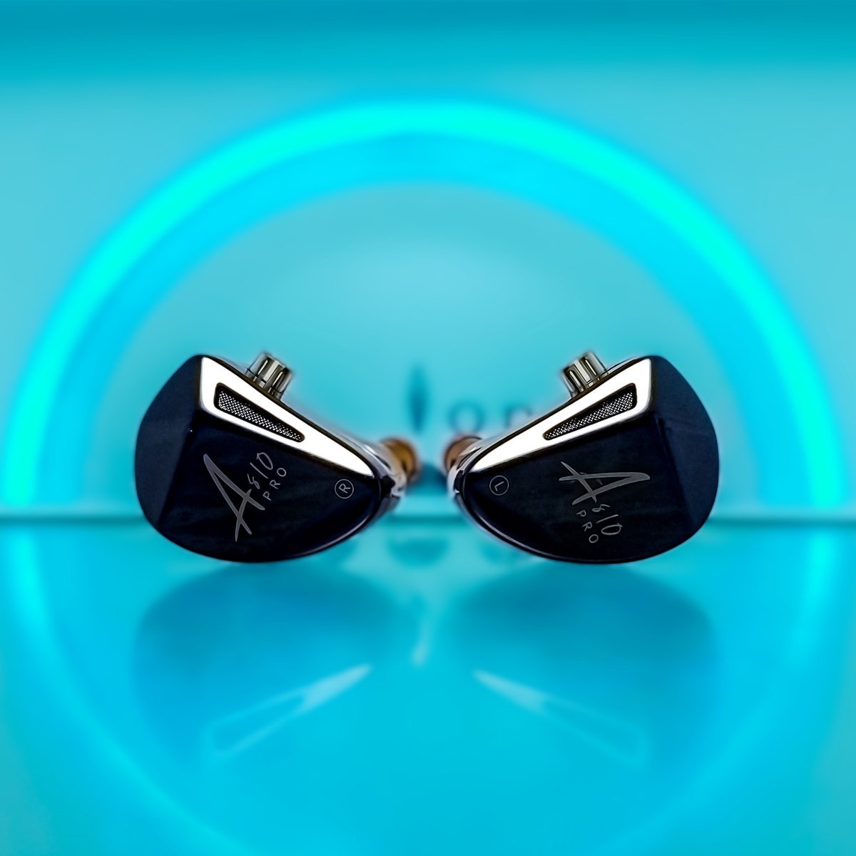 Two black in-ear monitors are placed symmetrically on a reflective blue surface. A glowing blue arc is in the background.