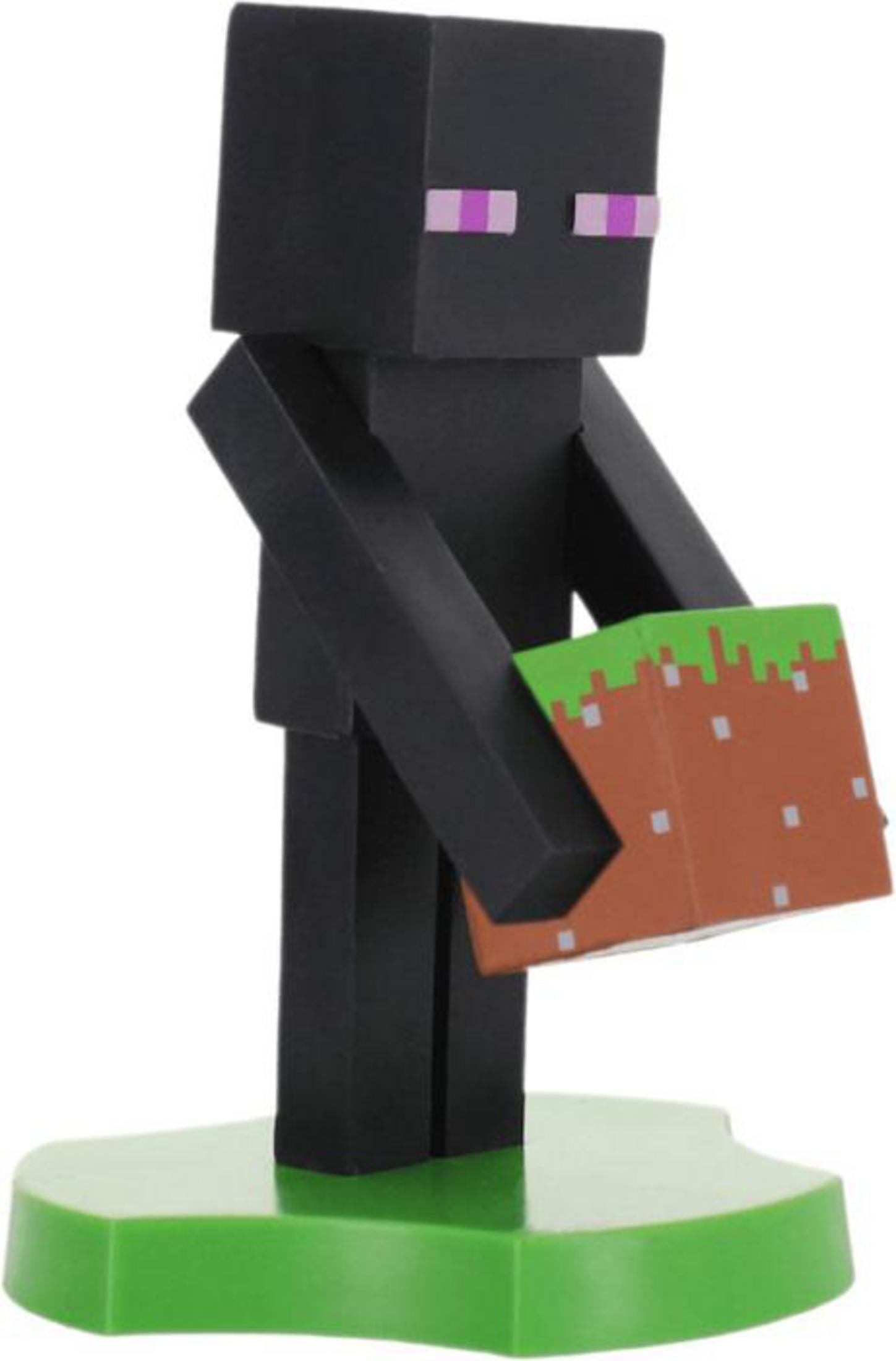 Eine Minecraft Enderman-Figur hält einen Erdblock. Sie steht auf einem grünen Sockel. Der Enderman ist schwarz mit lila Augen.