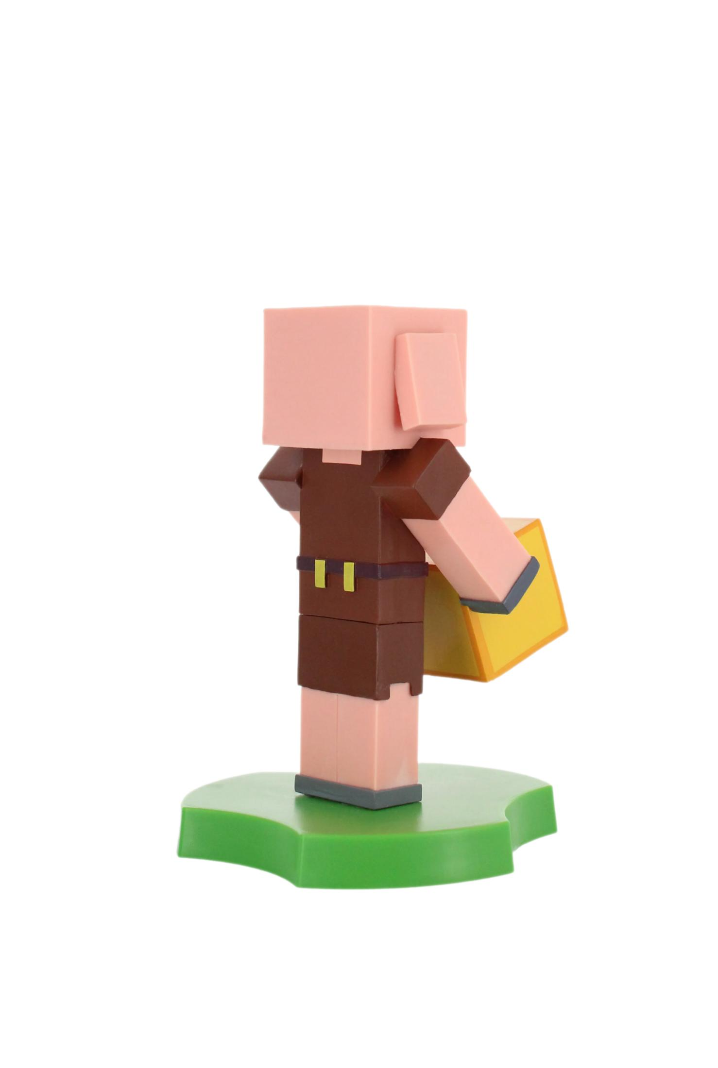 Eine Minecraft-Figur, ein Piglin, hält einen gelben Block. Es steht auf einer grünen Basis vor weißem Hintergrund.