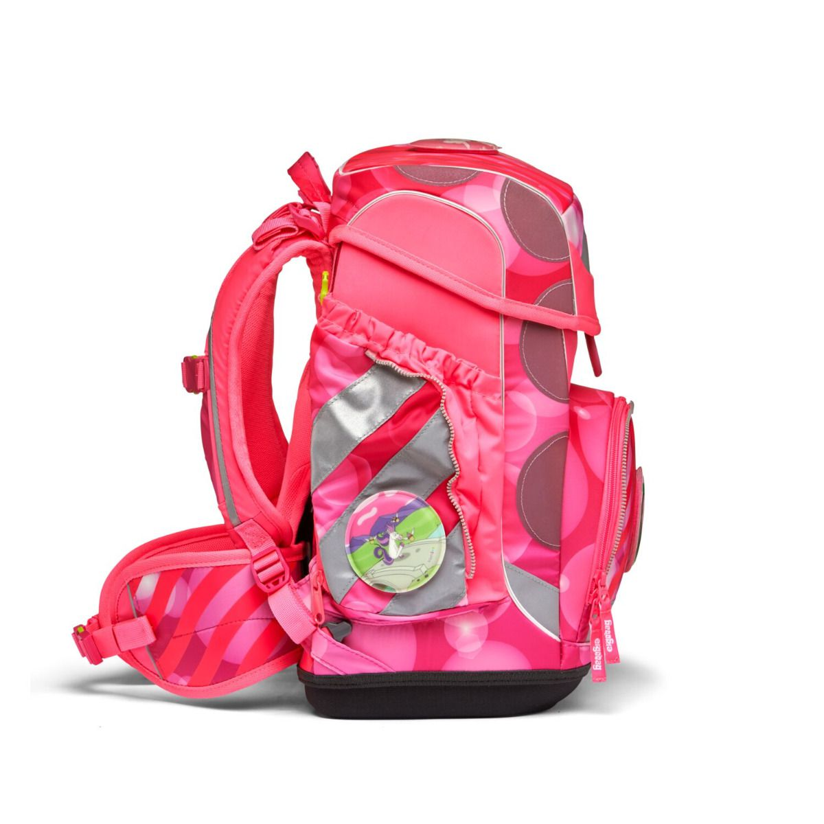 Rosa Schulrucksack mit Tupfen und reflektierenden Streifen. Mit rundem Abzeichen. Schwarze Basis und eine Seitentasche mit Reißverschluss.