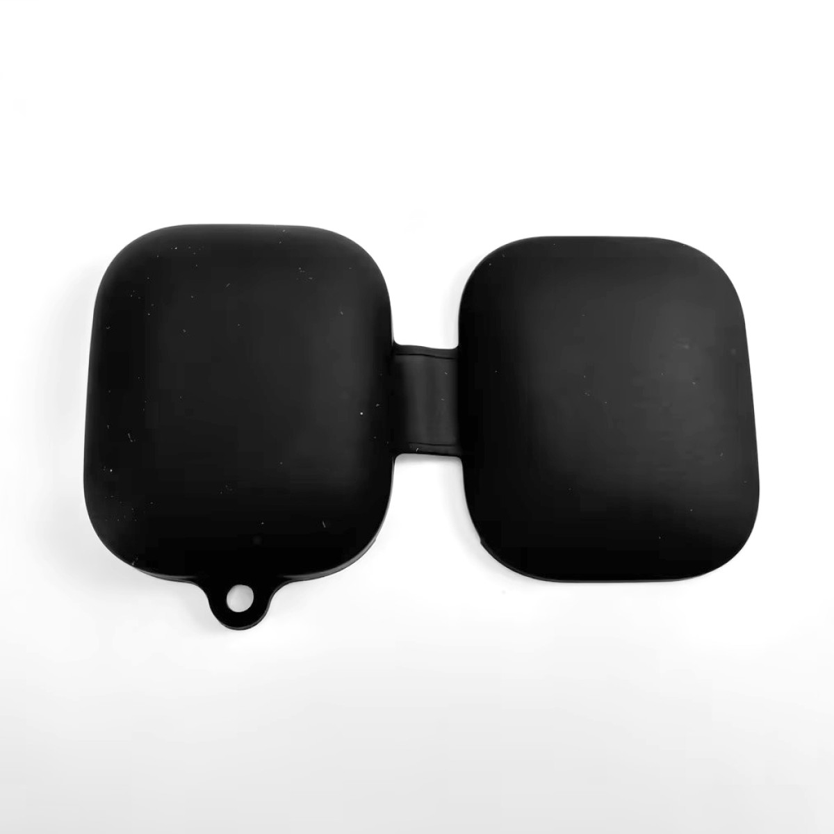 Un astuccio nero a due scomparti collegati con un piccolo foro. È su sfondo bianco. L'astuccio sembra essere di gomma.