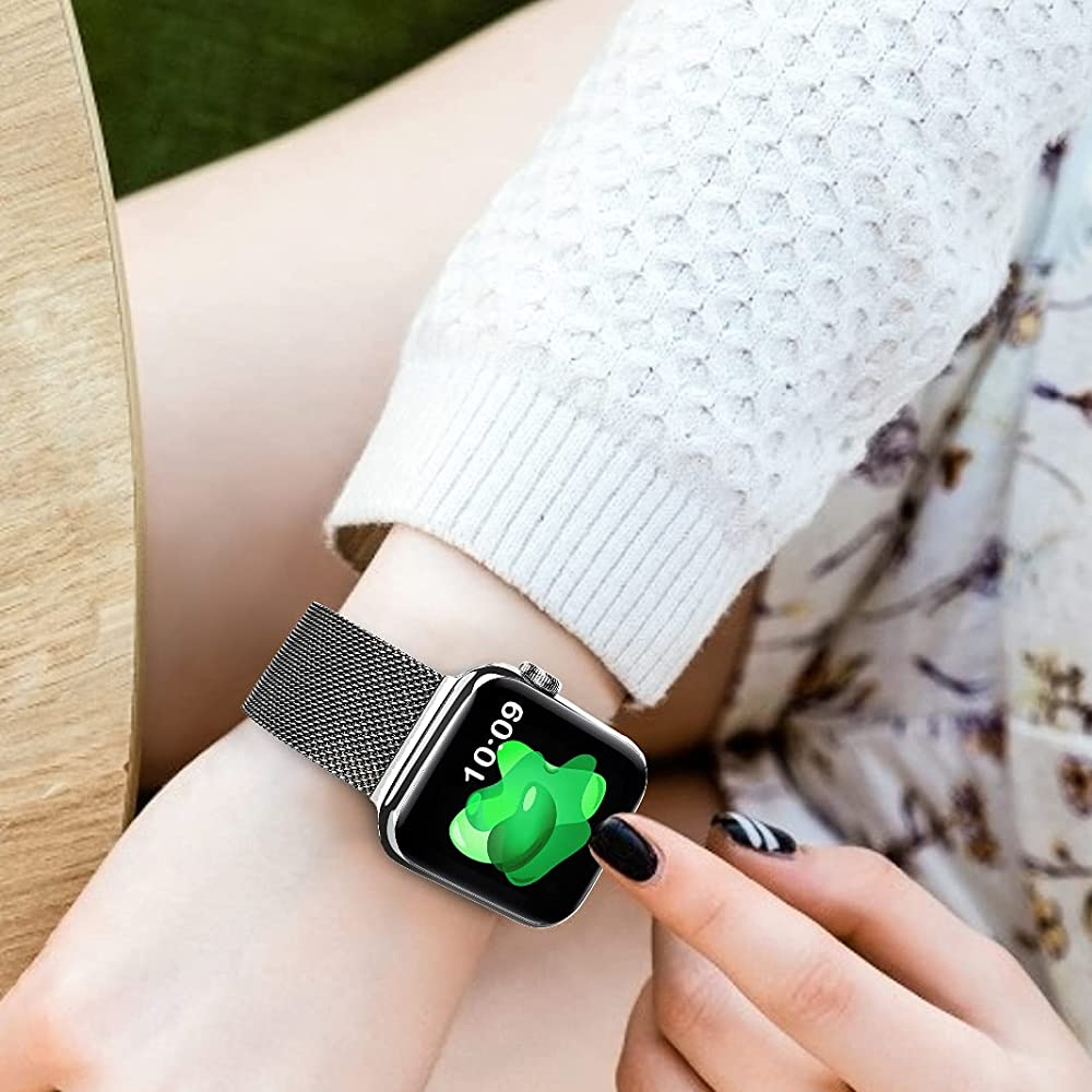 Eine Person trägt eine Smartwatch mit schwarzem Armband. Das Zifferblatt zeigt die Uhrzeit und eine grüne Form. Die Fingernägel sind schwarz lackiert.