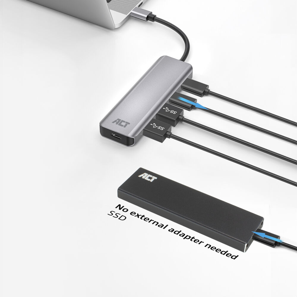 Un hub USB argentato collegato a un laptop. Cavi neri portano a un case SSD nero. Testo: Nessun adattatore esterno necessario.