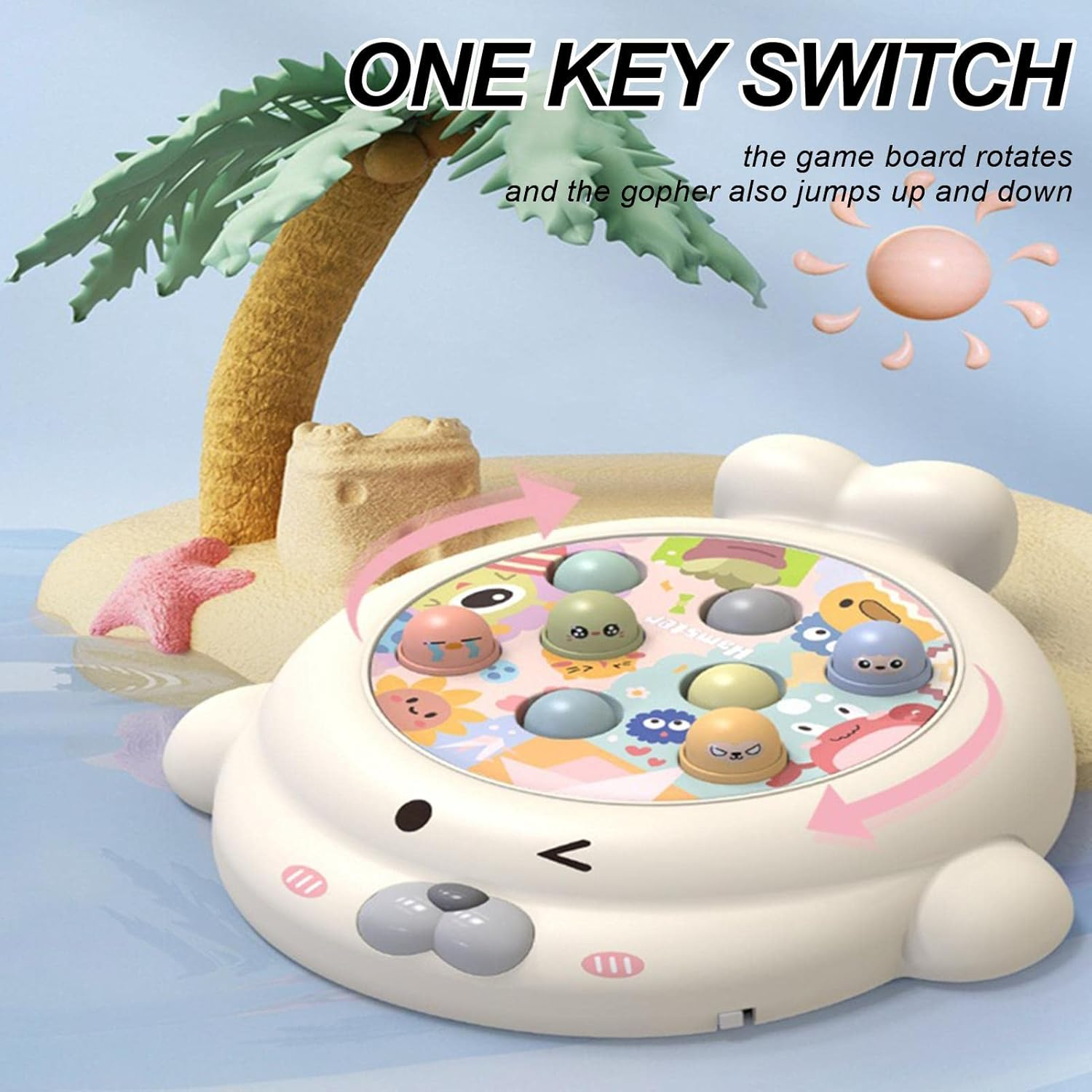 Ein Spielzeug mit Seehundform und bunten Knöpfen. Im Hintergrund sind eine Palme und eine Sandburg mit einer Sonne. Text: One Key Switch.