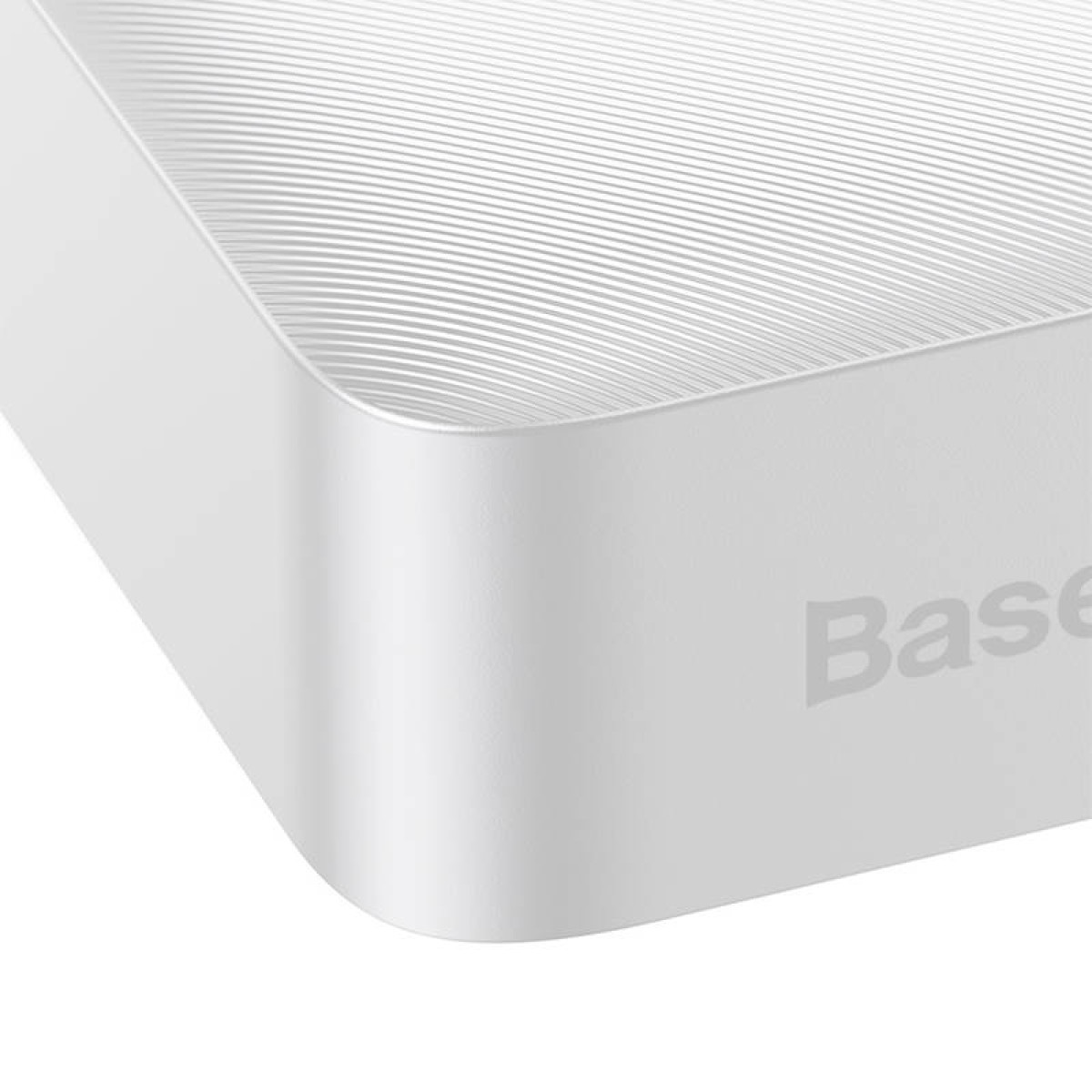 Angolo di un dispositivo bianco con bordi arrotondati. La parte superiore ha linee strutturate. Visibile la parola 'Base'.