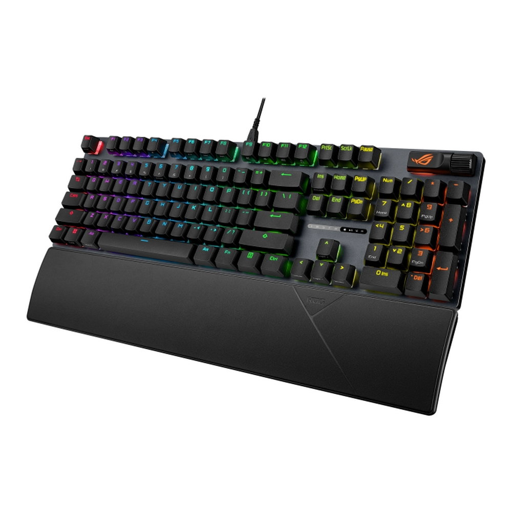 Una tastiera ROG nera con tasti retroilluminati multicolore. Ha un poggiapolsi. I tasti sono etichettati e c'è un logo ROG.