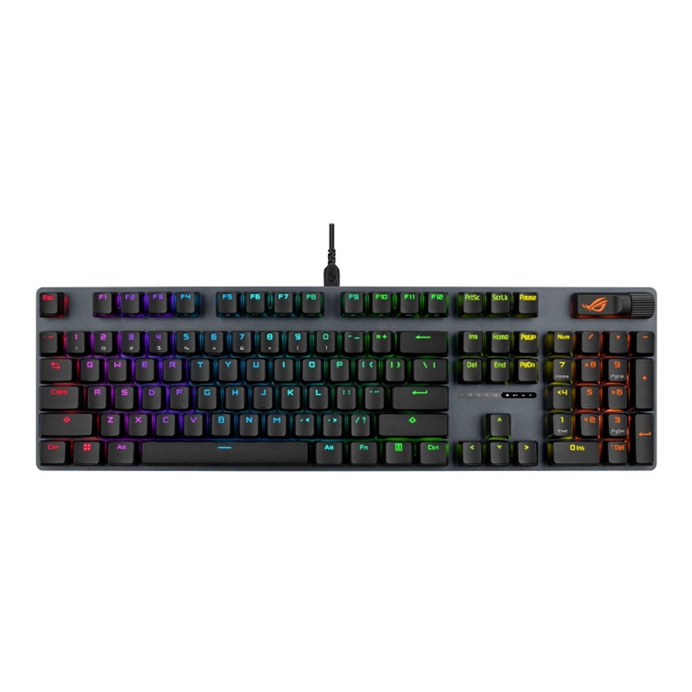 Una tastiera meccanica grigia con illuminazione RGB. I tasti sono etichettati con lettere, numeri e simboli. Un cavo USB si collega nella parte superiore.