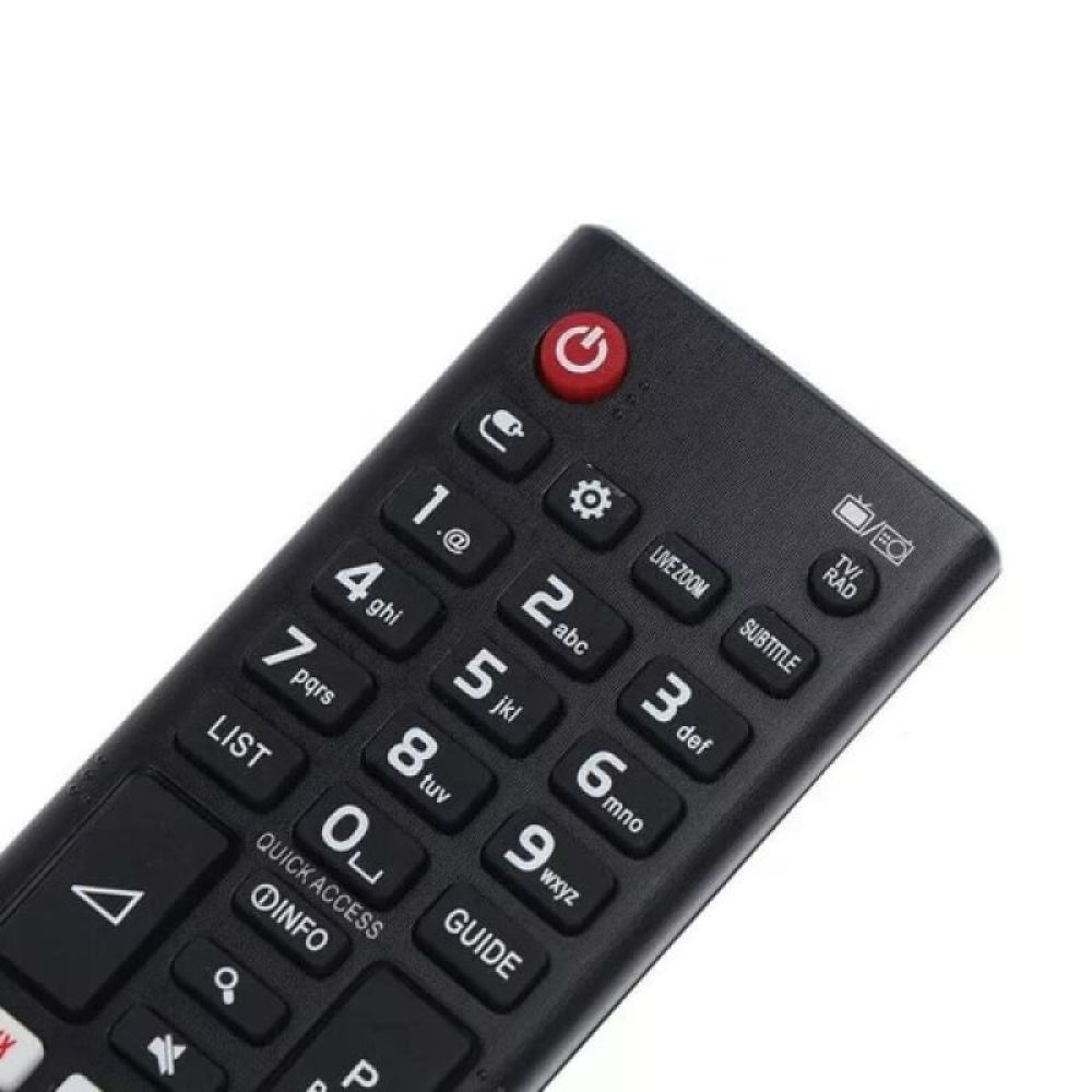 Nahaufnahme einer schwarzen TV-Fernbedienung. Sie hat viele Tasten mit Zahlen, Symbolen und Funktionen wie 'TV/RAD' und 'Untertitel'.