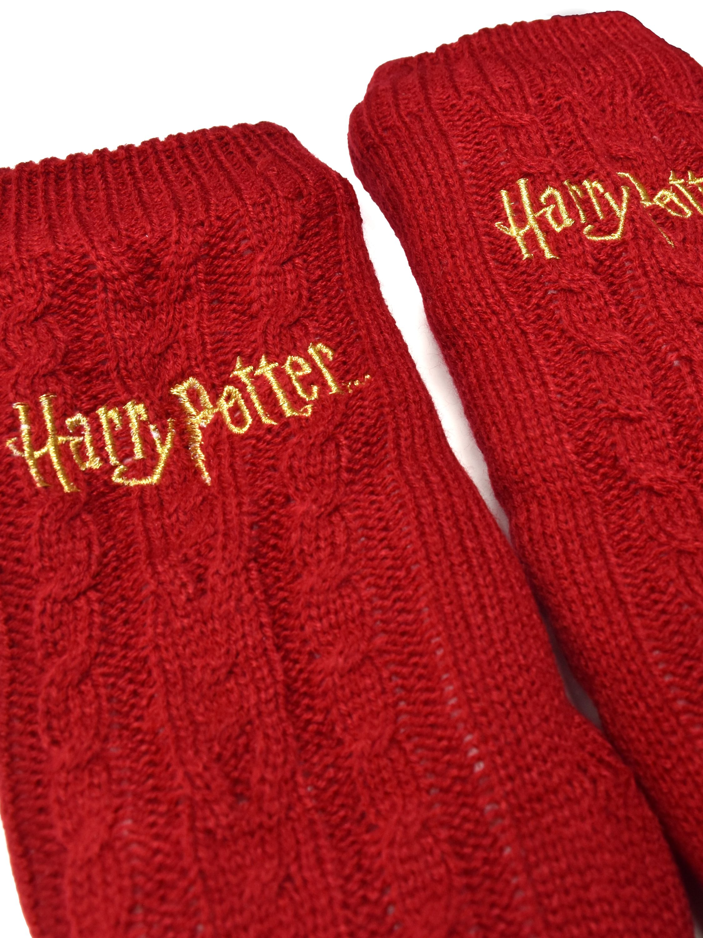 Zwei rote Stricksocken mit goldenem "Harry Potter" -Text.