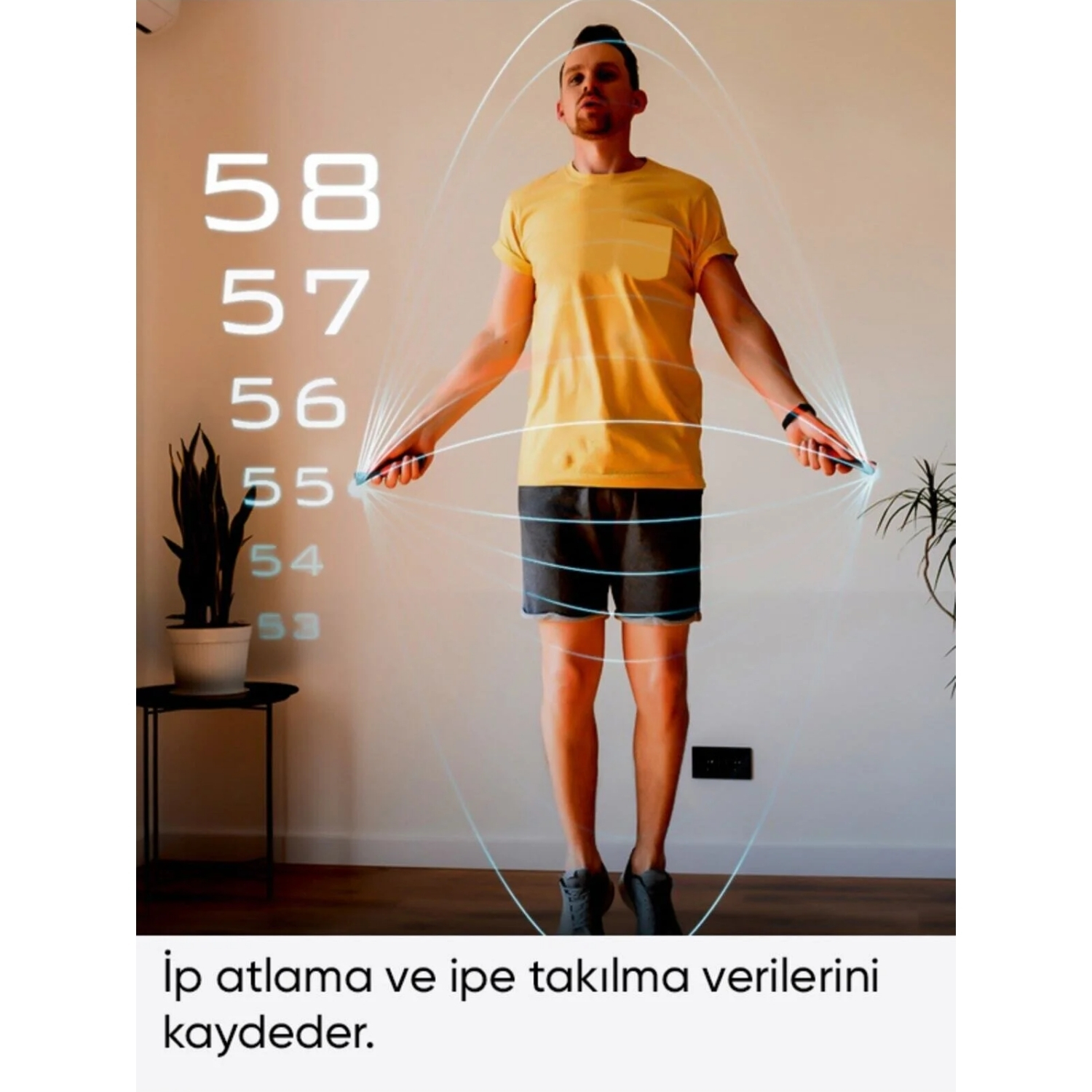 Sarı tişörtlü bir adam ip atlıyor. Üzerinde rakamlar beliriyor. Solda bir bitki ve küçük bir masa var. Metin Türkçe.