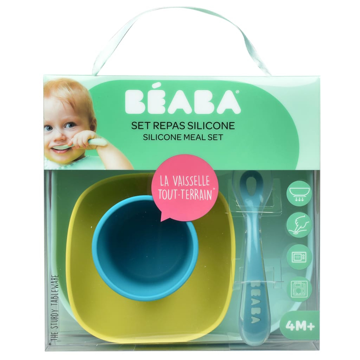Ein Baby-Ess-Set in einer Box. Es enthält einen gelben Teller, einen blauen Becher, einen blauen Löffel und ein Babygesicht auf der Verpackung.