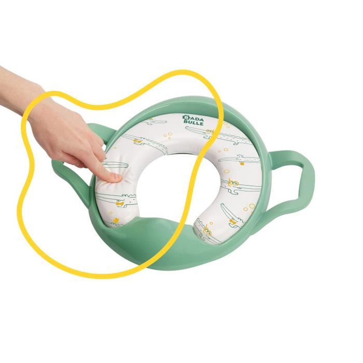 Ein grüner Toilettensitz mit weißem Kissen, eine Hand zeigt darauf. Das Kissen hat Krokodilmuster. Das Logo lautet Dada Bulle.