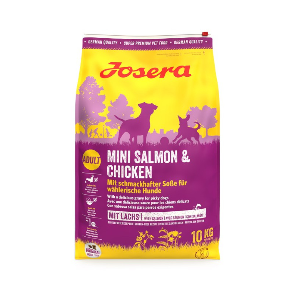 Una bolsa de comida para perros con texto 'Mini Salmón y Pollo'. Predominan los colores morado y amarillo. Contiene dibujos de perros y árboles.