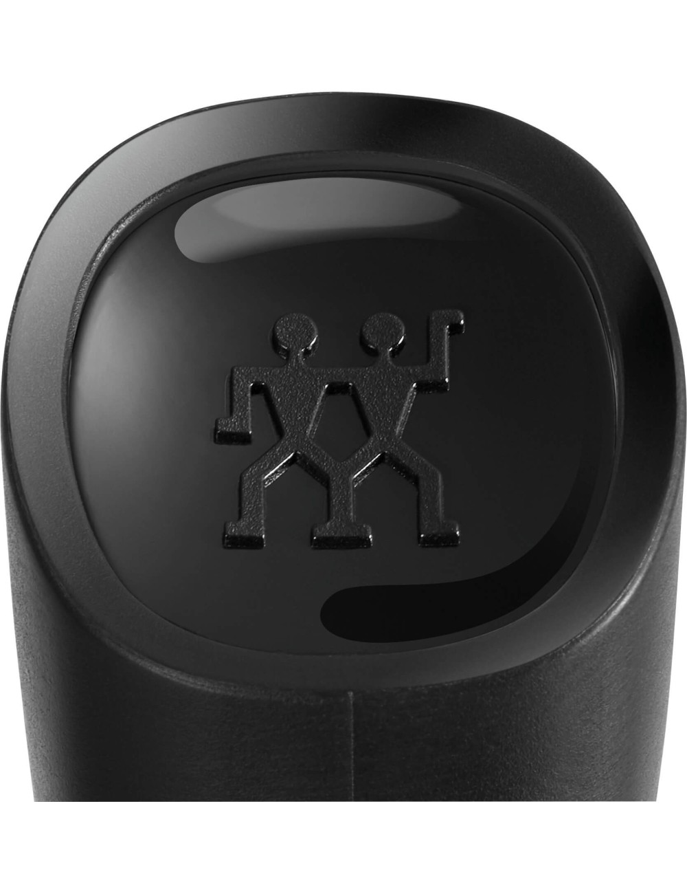 Zbliżenie czarnego obiektu z okrągłym wierzchem. Ma błyszczącą powierzchnię z logo dwóch postaci. Tło jest rozmyte.