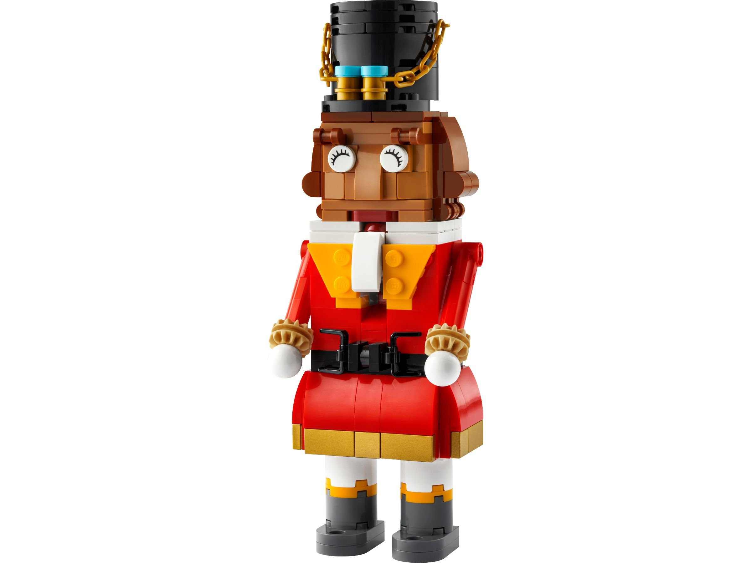 Eine Lego-Nussknackerfigur steht. Sie hat einen schwarzen Hut, ein braunes Gesicht, einen roten Mantel und graue Stiefel.