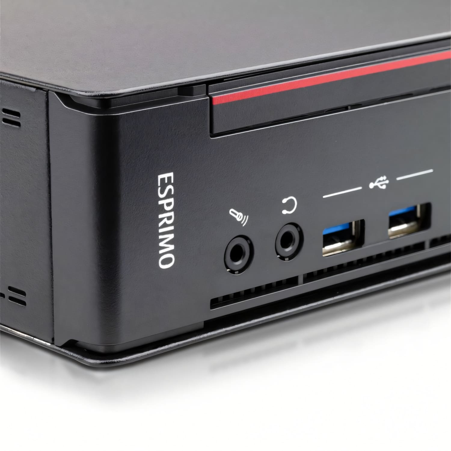 Ordenador negro con raya roja, texto ESPRIMO y puertos para audio, USB y micrófono. Fondo blanco.