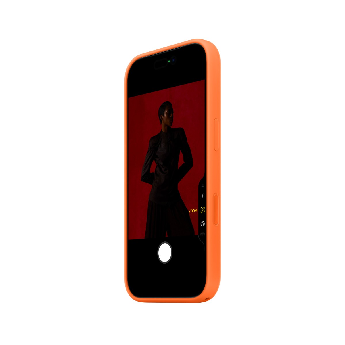 An orange phone displays a photo of a person in black clothing against a red background. The phone is angled.