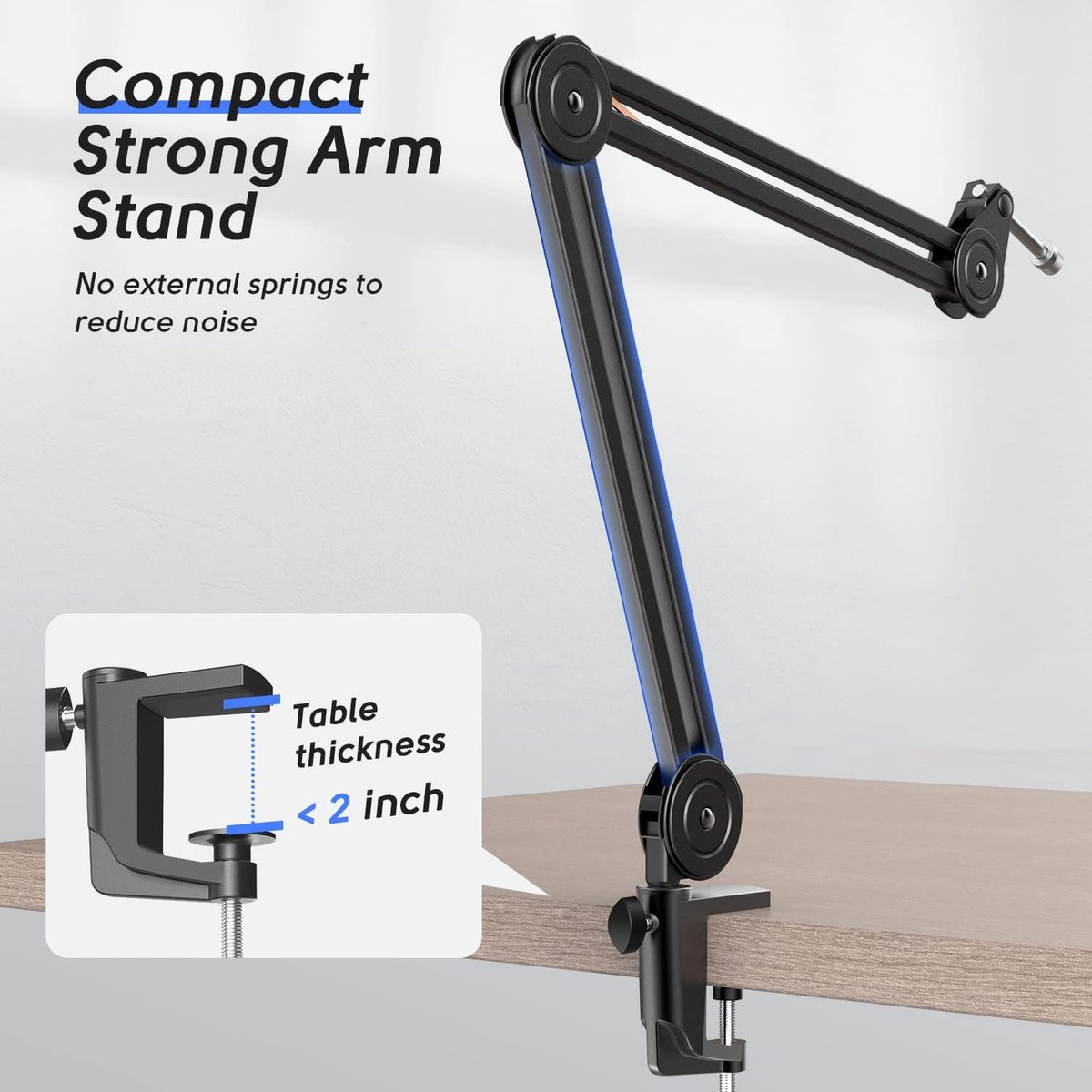 Een zwarte armstandaard is bevestigd aan een tafel. De tekst luidt 'Compact Strong Arm Stand'. Vermeldt dat de tafeldikte minder dan 2 inch moet zijn.