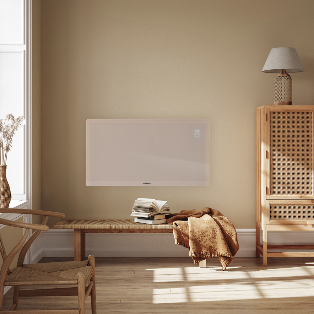 A room with a bench, a heater, and a cabinet. A blanket and books are on the bench. A lamp sits atop the cabinet.