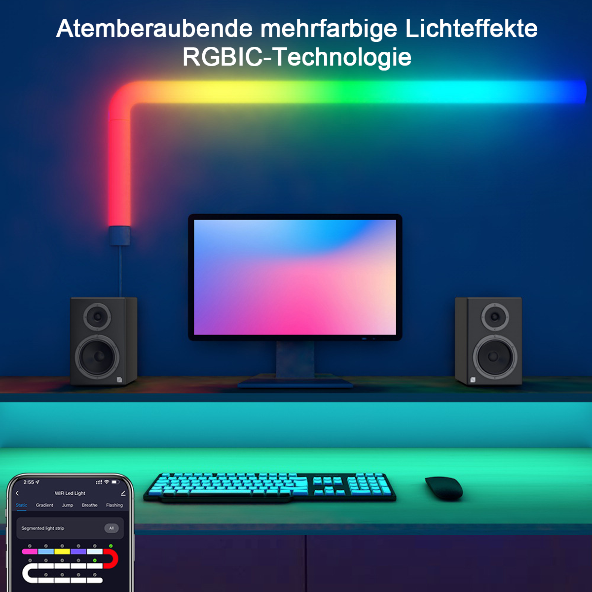 Ein Schreibtisch mit Monitor, Lautsprechern, Tastatur und Maus. Über dem Schreibtisch befindet sich ein mehrfarbiger Lichtstreifen.