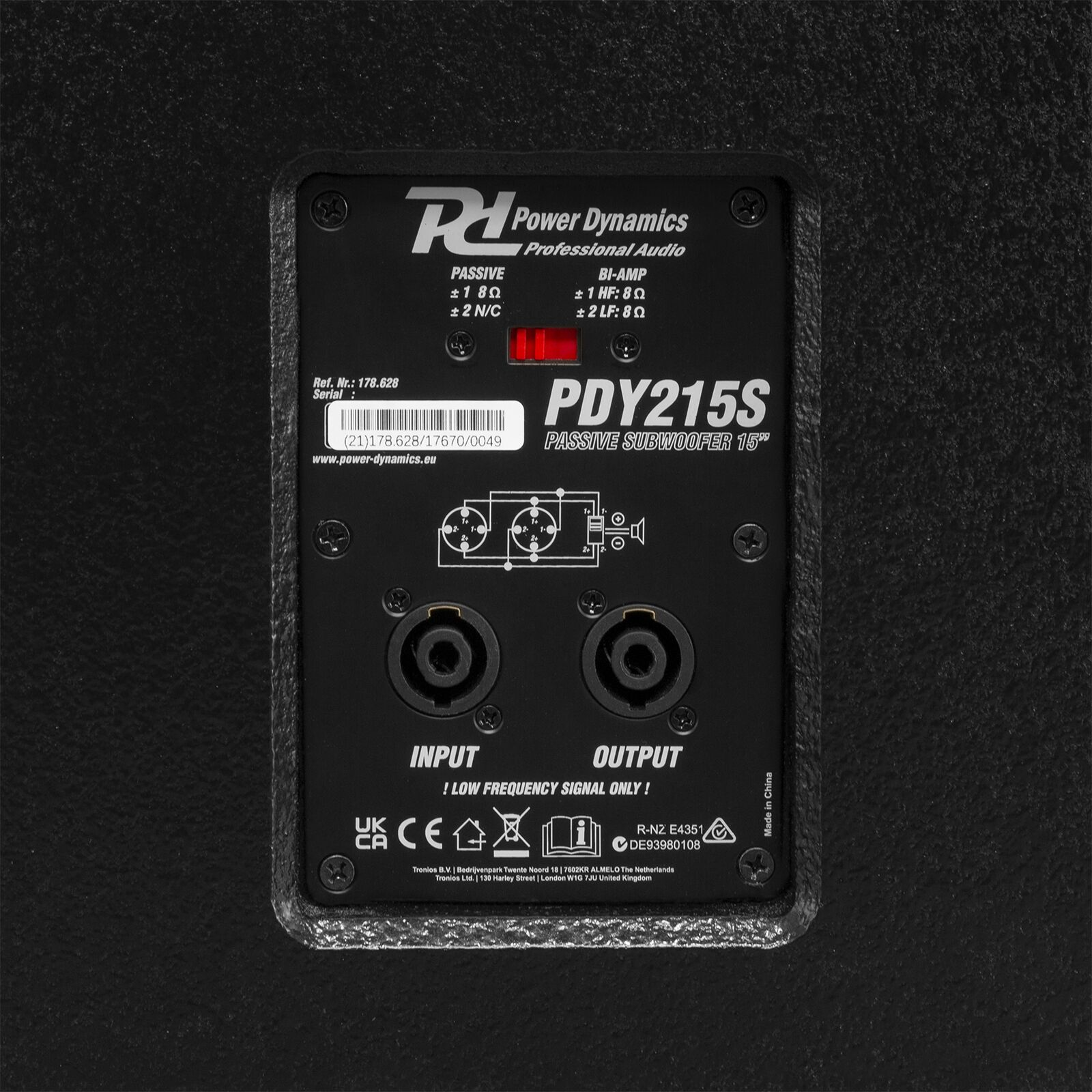 Panel negro de subwoofer con texto y conectores de entrada/salida. La marca es Power Dynamics.