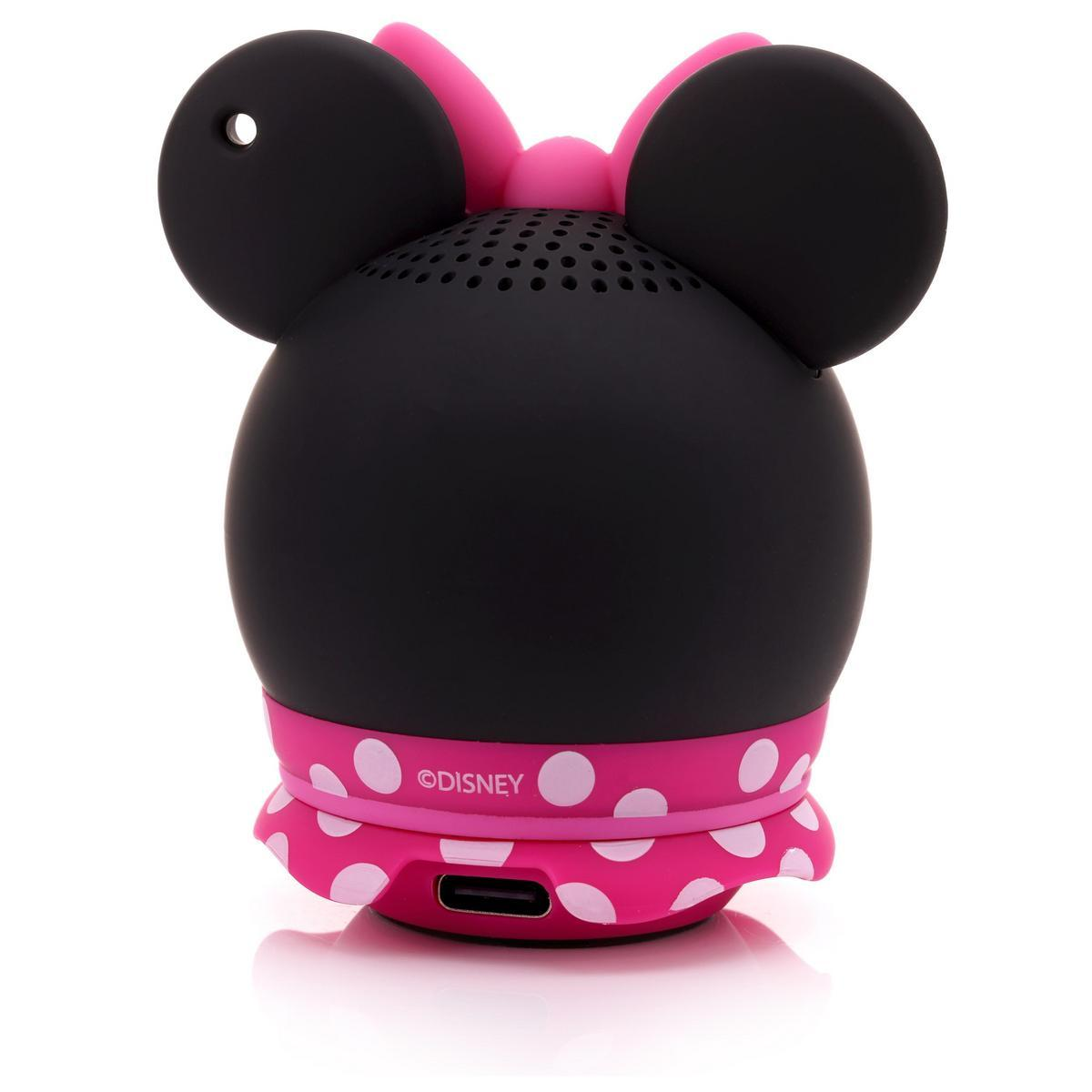 Ein Minnie-Mouse-Lautsprecher mit schwarzem Kopf, rosa Schleife und gepunktetem Rock. Der Lautsprecher hat große schwarze Ohren und einen Anschluss.