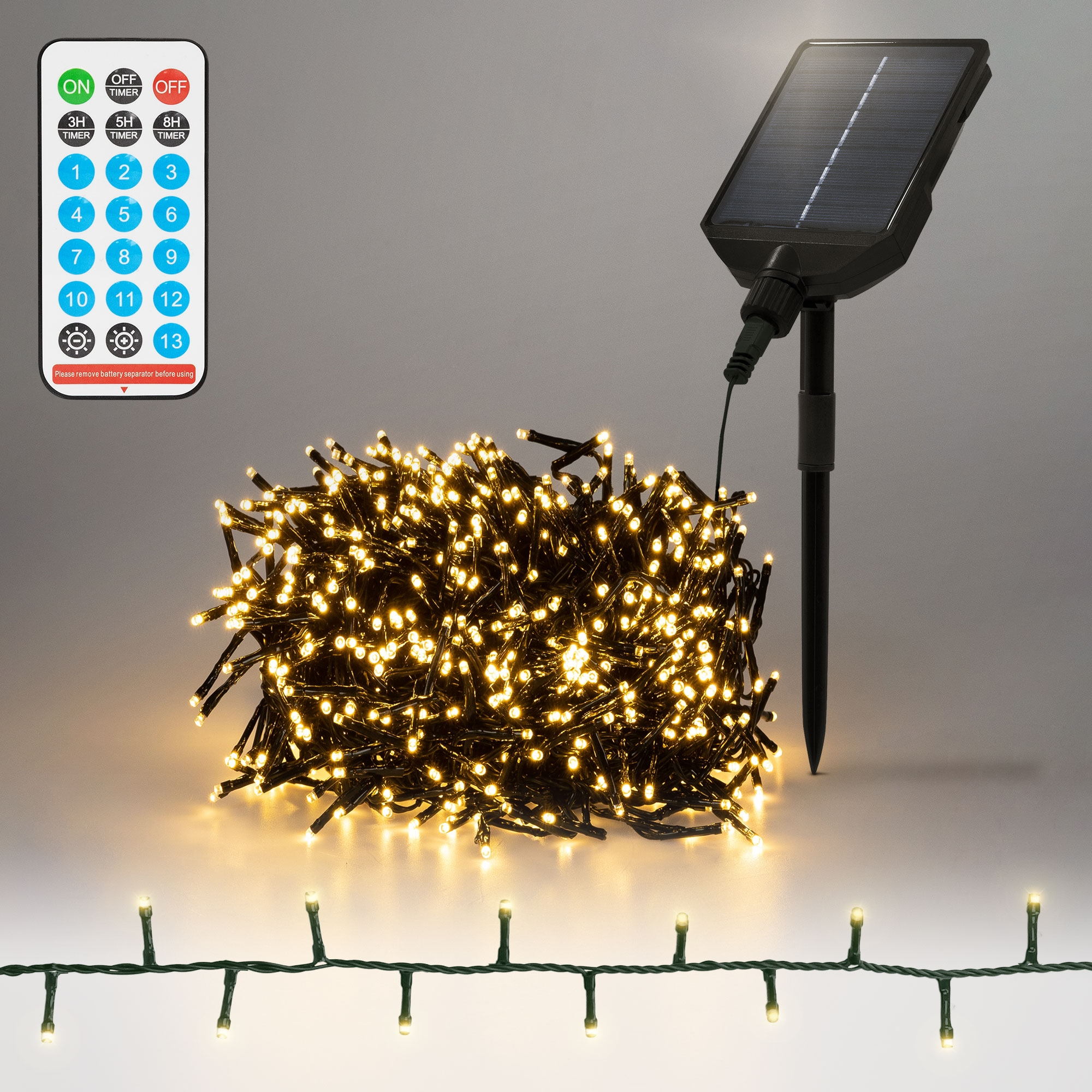 Solarbetriebene Lichterkette mit Fernbedienung. Die Lichter sind warmweiß, mit einem Solarpanel und einem grünen Draht.