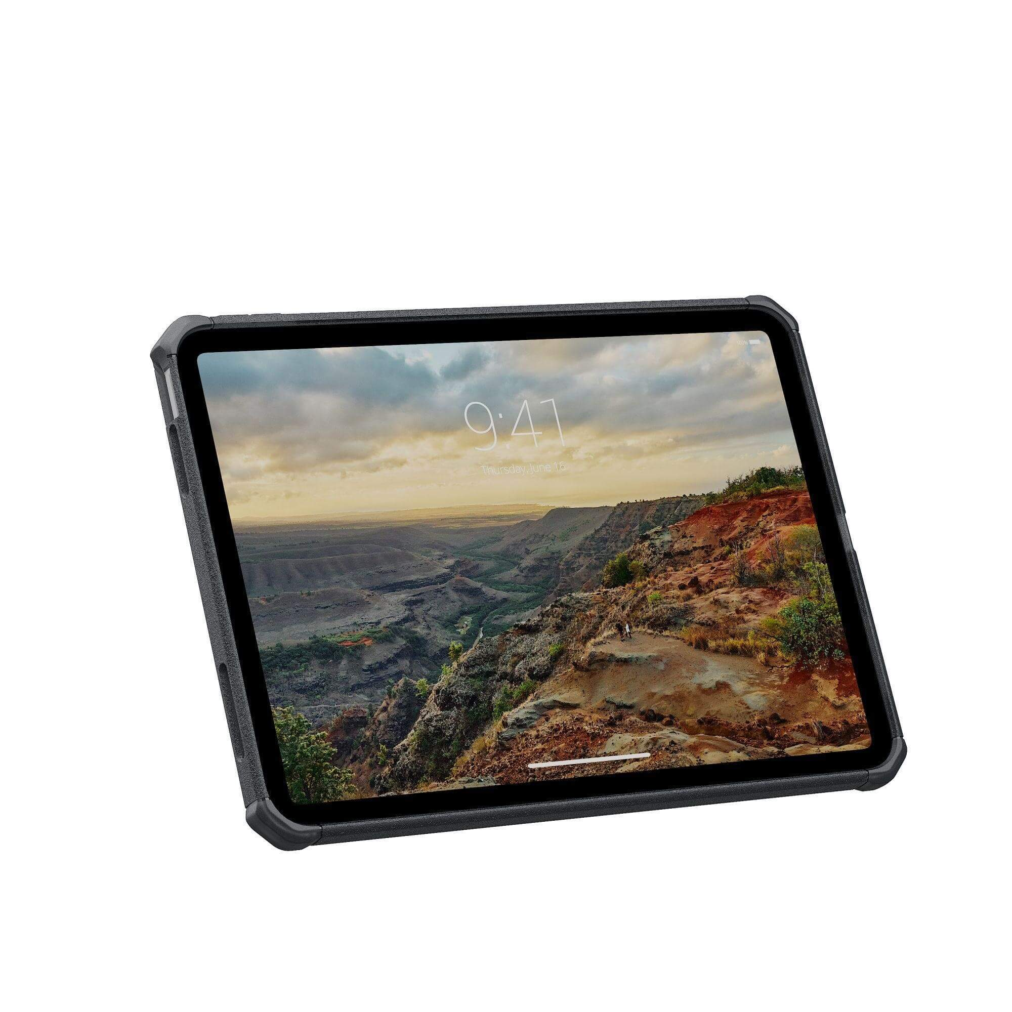 Tablet z krajobrazem, kanionem i szczegółami czasu, w czarnym etui.