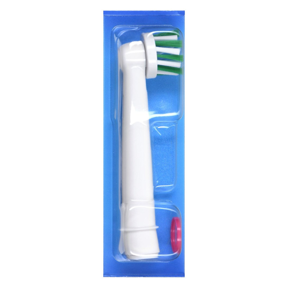 Un cabezal de cepillo de dientes blanco con cerdas verdes y blancas, encerrado en un empaque de plástico azul. Un anillo rosa en la parte inferior.