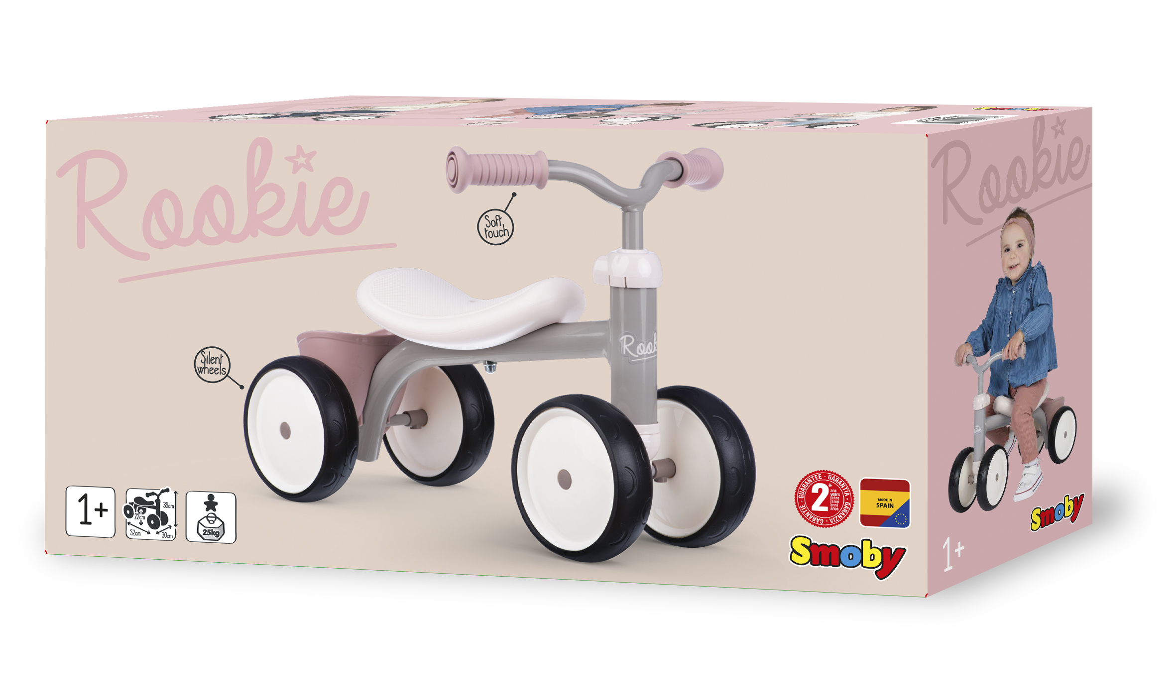 Auf der Verpackung ist ein rosa-graues Smoby Rookie Laufrad abgebildet. Auf der Seite der Box fährt ein Kind ein ähnliches Rad.