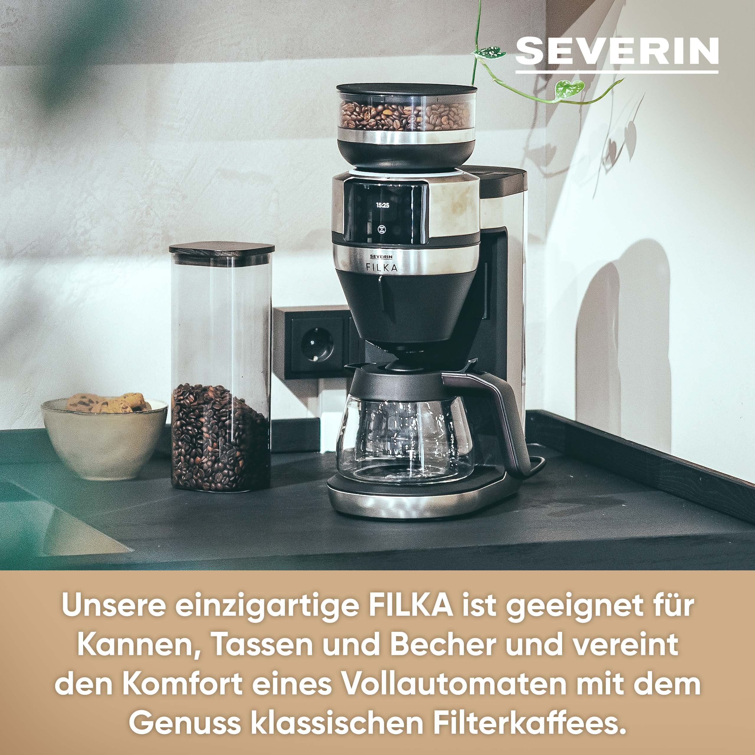 Coffee machine with coffee beans in a glass jar and a bowl of cookies on a black surface.