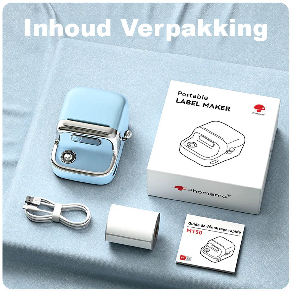 A label maker, box, roll of labels, charging cable and manual are on a blue surface. The label maker is light blue.