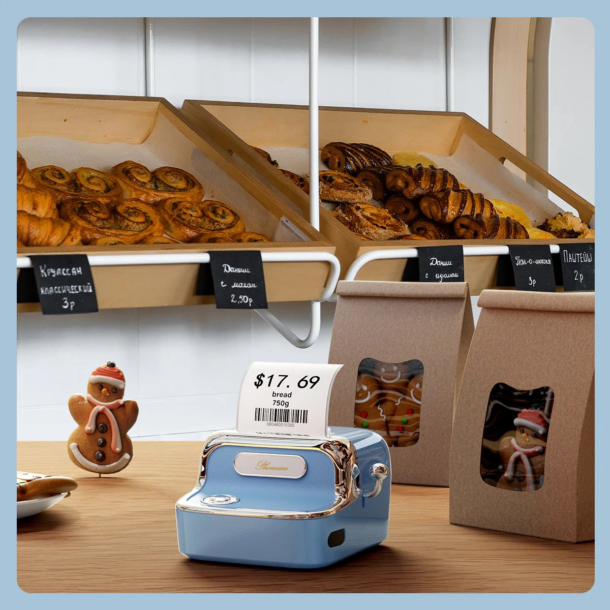 Bakery scene with pastries, a blue cash register, and gingerbread cookies. Price tag shows $17.69 for bread.