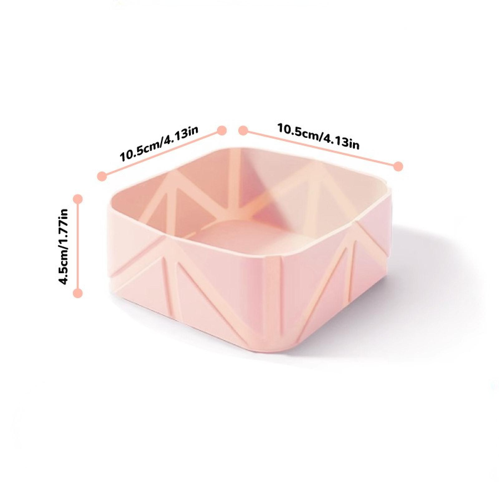 Ein rosafarbener, geometrischer Behälter wird gezeigt. Die Abmessungen sind beschriftet: 10,5 cm/4,13 Zoll und 4,5 cm/1,77 Zoll. Er steht auf weißem Grund.
